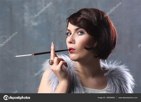 Woman Smoking With Cigarette Holder — Stock Photo © Belchonock 148526605