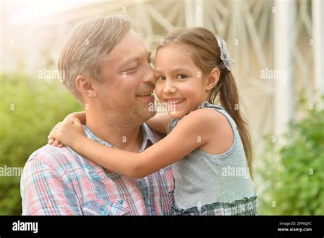 Portrait Of Happy Father And Daughter Hugging Outdoors Stock Photo Alamy