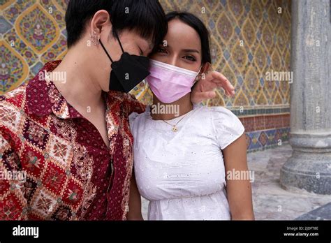 Multicultural And Transgender Couple Embracing Tenderly Outside A