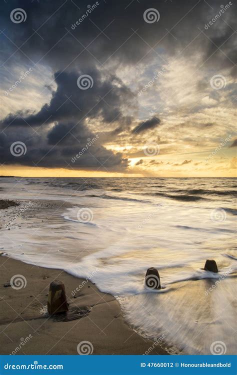 Beautiful Vibrant Seascape At Sunset Image With Dramatic Sky And Stock