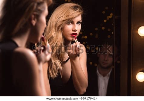 Young Woman Is Putting On Her Make Up