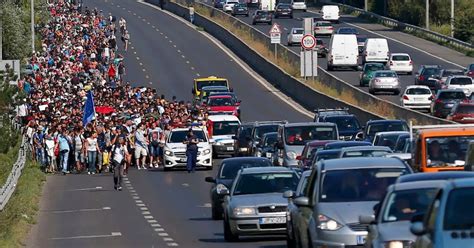 Thousands Of Refugees Begin Walking Along Motorway To Austria After Hungarian Authorities Refuse