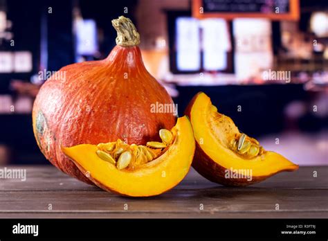 Group Of One Whole Two Slices Of Fresh Red Kuri Pumpkin Hokkaido