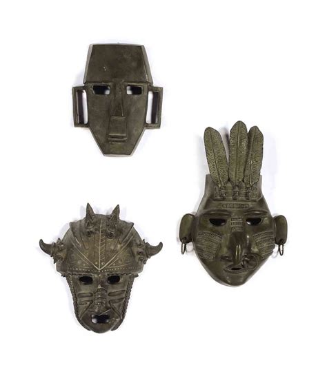 A Group Of Six Patinated Bronze Masks