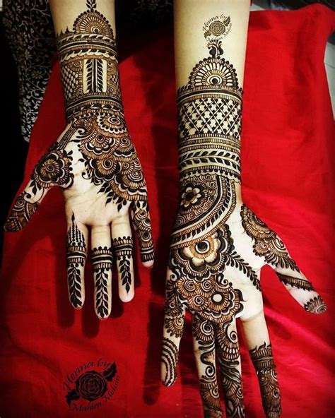 Two Hands With Henna Tattoos On Them