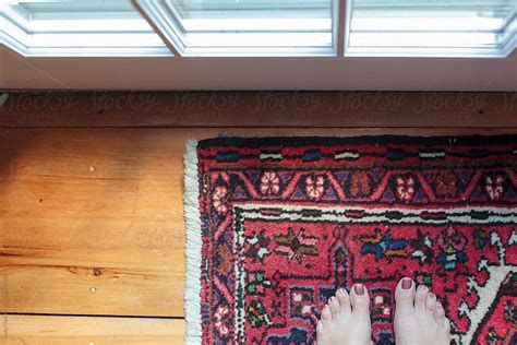 Looking Down On Woman S Feet Standing On Oriental Carpet Del Colaborador De Stocksy Holly