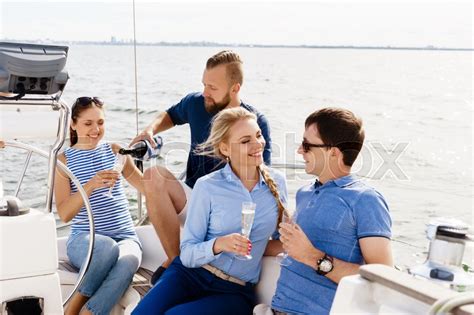 Group Of Happy Friends Having A Party On A Yacht And Drinking Champagne