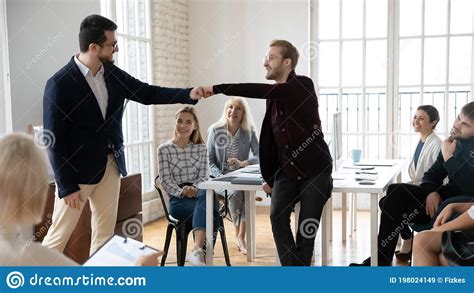 Smiling Male Colleagues Give Fist Bump Greeting Stock Image Image Of Collaboration