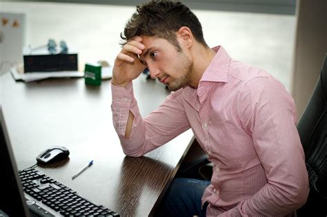 Preoccupied Worried Young Male Worker Staring At Computer Paper Monkey
