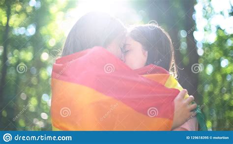 Lesbian Lovers Wrapped In Rainbow Flag Kissing Tenderness And Love