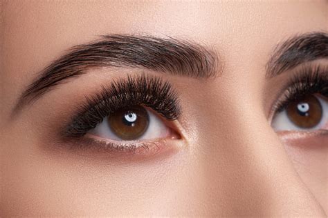 The Eyes And Eyebrows Of A Woman With Long Lashes Are Shown In This