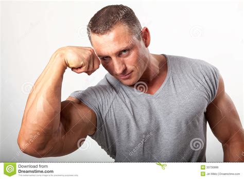 Muscular Man Flexing His Biceps On White Royalty Free