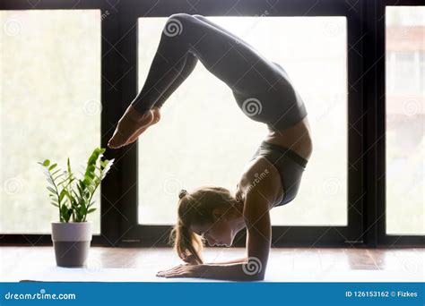 Young Sporty Woman Doing Yoga Scorpion Backbend Pose Stock Photo