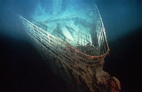 An Old Ship In The Water With Rope On Its Side And Light Shining From