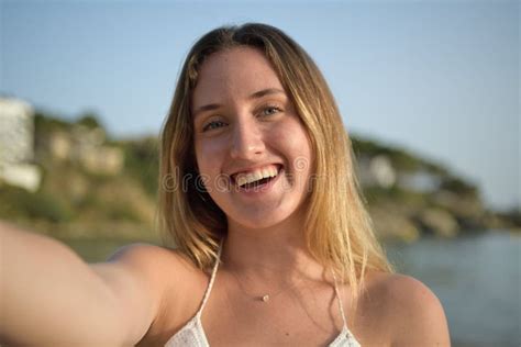 Close Up Portrait Of A Girl Laughing And Taking Selfie On The Beach