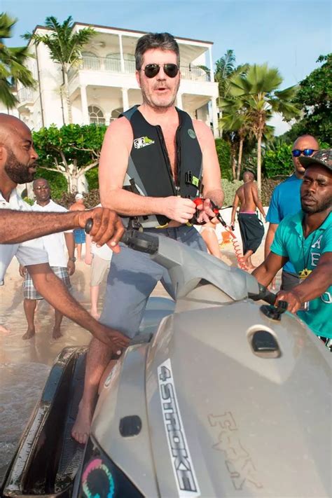 simon cowell makes a splash on a jet ski as lauren silverman stuns in red swimsuit on barbados