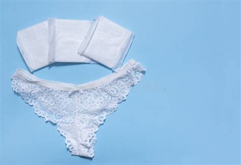 1 women`s white lace panties sanitary pads on blue background stock image image of care