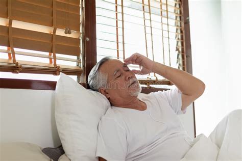 Asian Elderly Senior Man Back Pain And Illness On Bed At Homeunhappy
