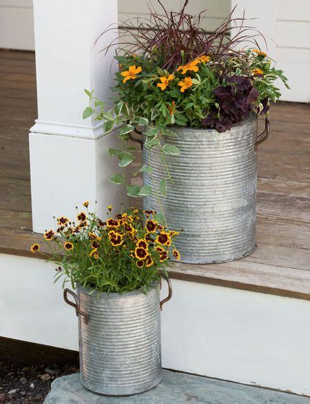 Galvanized Metal Planters With A Rim And Handles In