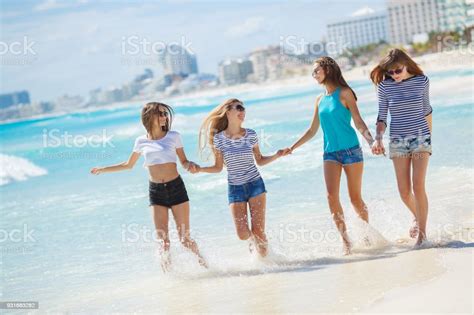 Four Beautiful Women Spend Time On The Beach At A Wonderful Resort In