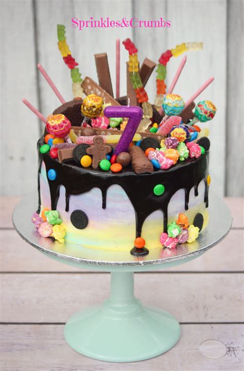 Rainbow Candy Drip Cake Pale Frosting Paired With Crazy Toppings