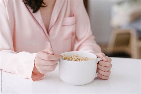 Anonymous Woman Eating Cereals With Milk By Stocksy Contributor Branislava Ivi Stocksy