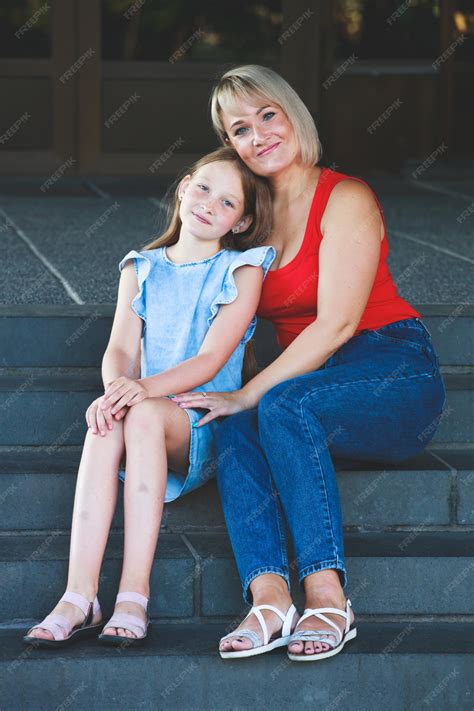 Premium Photo Beautiful Blonde Mom In A Red T Shirt With Her Daughter Group Portrait
