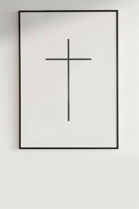 A Cross On A White Wall Above A Black Frame