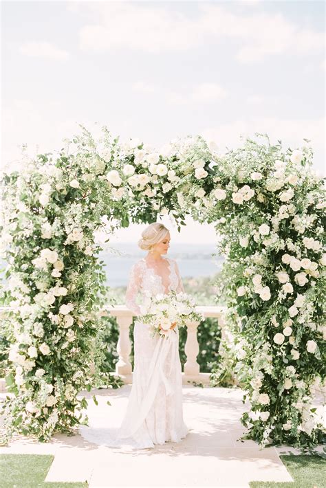 wedding photos altar floral arch outdoor ceremony greenery white roses wedding florals