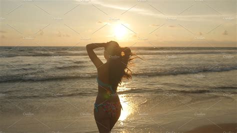 Attractive Sexy Girl With Long Hair Posing On The Ocean Shore At Sunrise Beautiful Young Woman