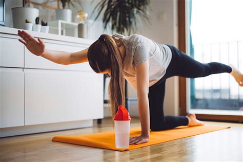 Active Pregnant Woman Working Out Water Bottle Next To Her Stock Photo