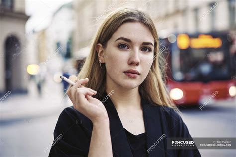Portrait Of Young Woman Smoking At Street — Attractive Cigarette