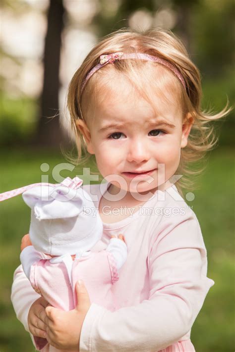 Little Girl With Doll Baby Crying Stock Photos