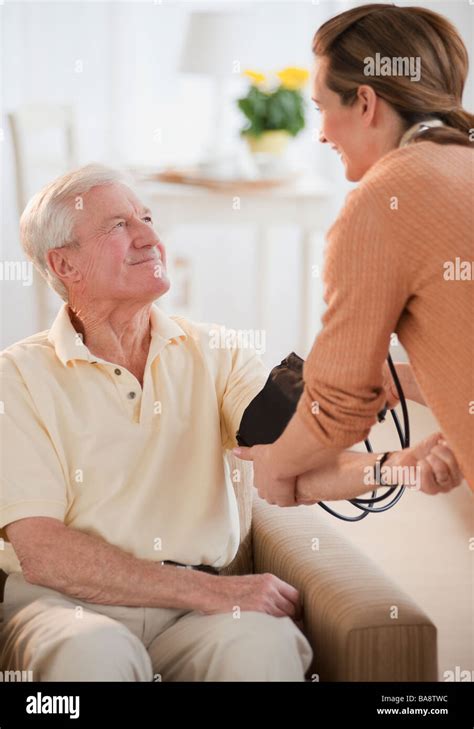 Nurse Taking Senior Mans Blood Pressure Stock Photo Alamy