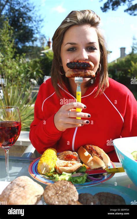 Young Woman Eating Sausages Model Released Stock Photo Alamy