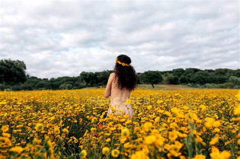 Back View Of Anonymous Naked Brunette In Flower Wreath Enjoying Meadow