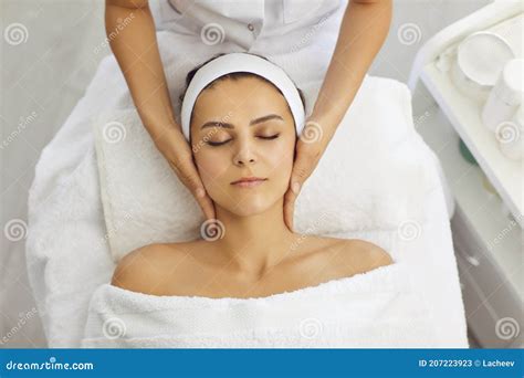 Spa Facial Massage Beautician Makes Face Massage To Woman In White Beauty Salon Stock Image