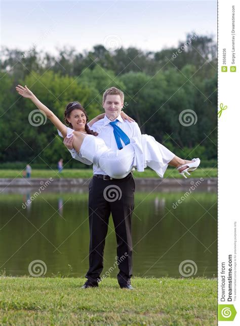 The Groom Holds His Bride In His Stock Photo Image Of Male Embracing