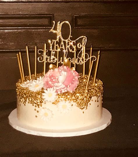 A 40th birthday cake can be decorated by coating it in a black fondant, and numbers can simply be made out of wood to stick in the cake. Gold and white 40th birthday cake | 40th birthday cakes ...