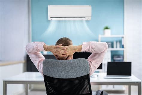 Relaxed Businessman Enjoying The Cooling Of Air Conditioner Stock Image