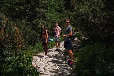 Group Of Tourists With Backpacks Descends Up Mountains Summer Hiking