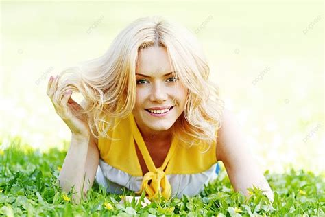 Smilng Happy Young Woman Lying On Green Grass Meadow Background Beauty
