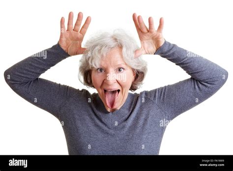 Silly Old Senior Woman Showing Her Tongue And Making A Face Stock Photo