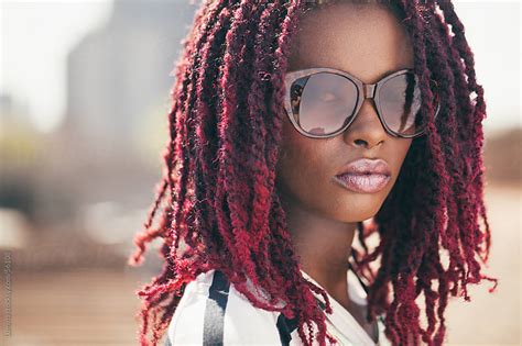 African Woman With Sunglasses And Pink Dreadlocks By Lumina Stocksy United