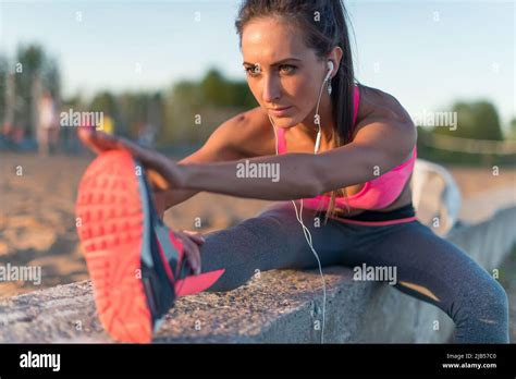 Fitness Model Athlete Girl Warm Up Stretching Her Hamstrings Leg And Back Young Woman