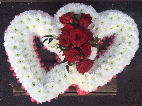 Maybe you would like to learn more about one of these? A double heart funeral tribute. Two hearts intertwined ...