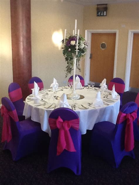 Wedding chairs with purple covers and white ribbons. Purple Lycra chair covers with hot pink fuschia taffeta ...