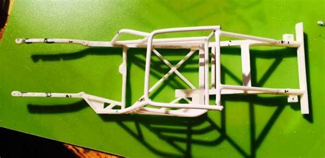 A Plastic Model Of A Bicycle Frame On A Green Surface