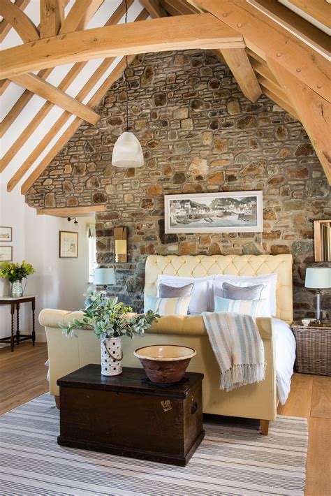 Welsh Long House Bedroom With Exposed Beams And Stone Wall Cottage