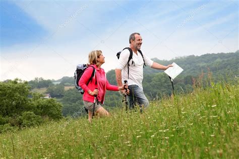 Senior Couple Hiking In Natural Landscape Stock Photo By ©goodluz 13940394